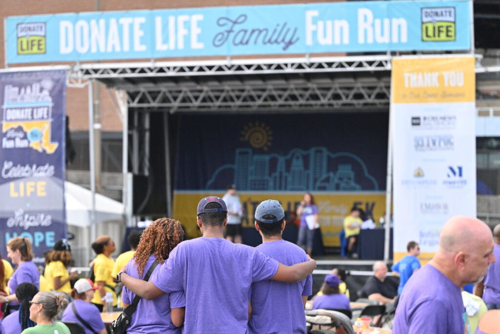 A family holding each other at Infinite Legacy's annual Donate Life Family Fun Run.