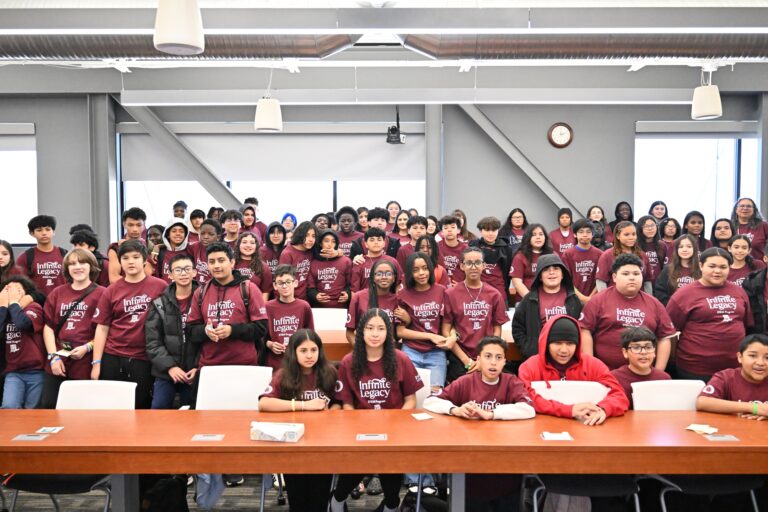 Group photo of middle school students wearing Infinite Legacy T-shirts after visiting Infinite Legacy's office to learn more about the organ procurement industry and the critical need for organ, eye and tissue donation.