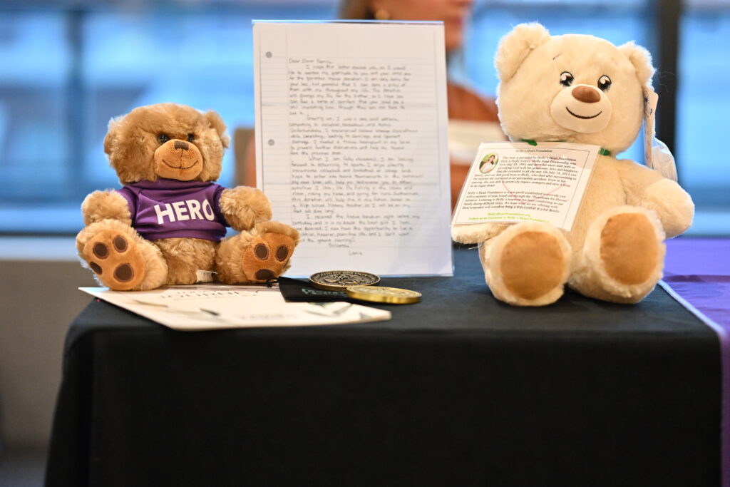 A hero heart bear and a recipients letter showcased at Infinite Legacy's Synergy Conference.
