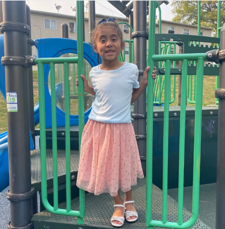 Heart recipient, Emily Bardales stands on a playground, enjoying her childhood and her second chance at life.