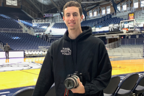 Donor hero Xan Korman at Butler University's basketball courts, ready to photograph the sport he loved most.