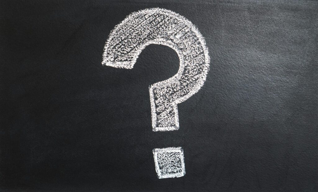 A conceptual image featuring a question mark drawn on a chalkboard.